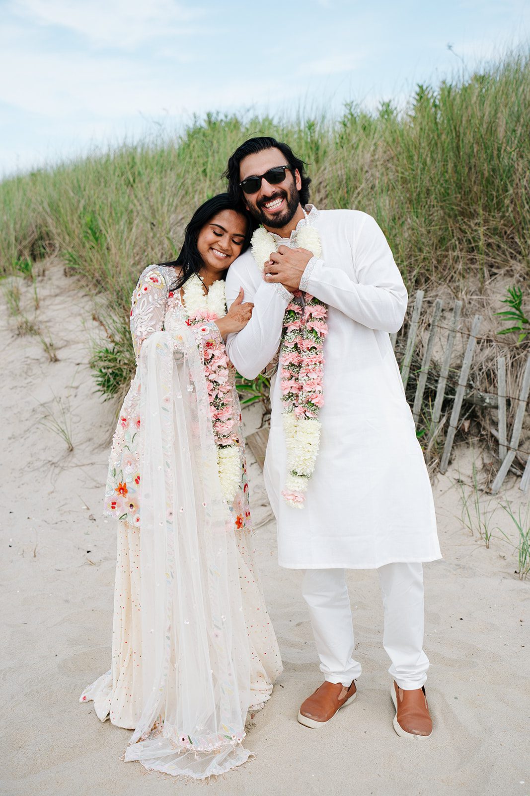 Couple leaning on each other at the beach